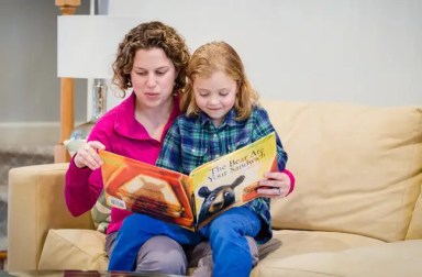 woman-reading-book-to-young-child