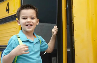 young-boy-boarding-school-bus