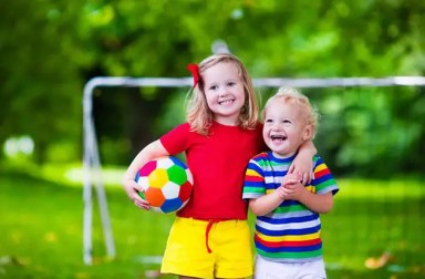 young-girl-and-young-boy-on-soccer-field-with-soccer-ball