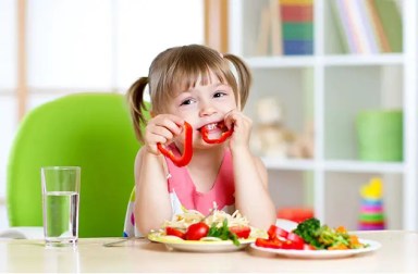 young-girl-eating-vegetables