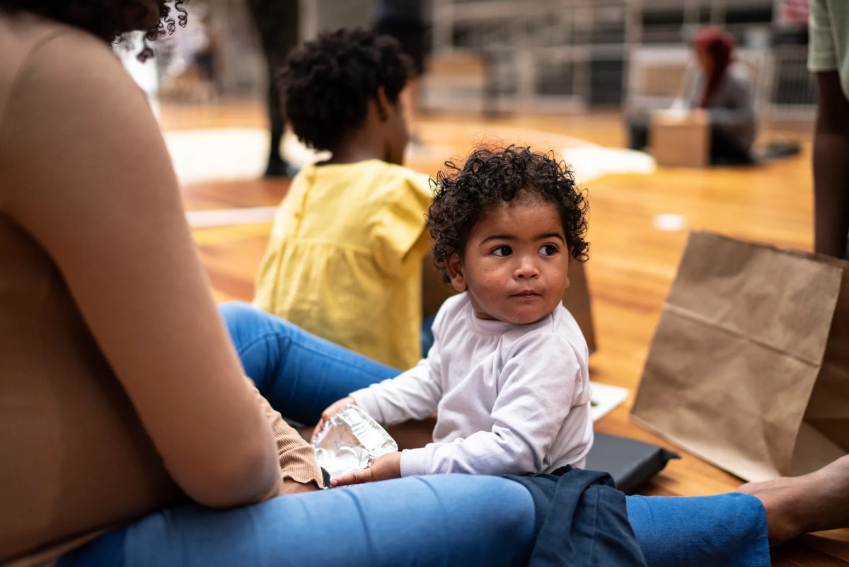 Baby boy with mother in a refugee sheltering